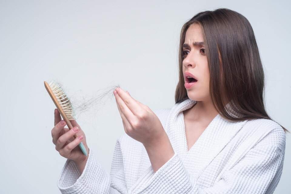 Shower Hair Fall Explained: When to Worry and When Not To 1 sad woman with hair loss problem